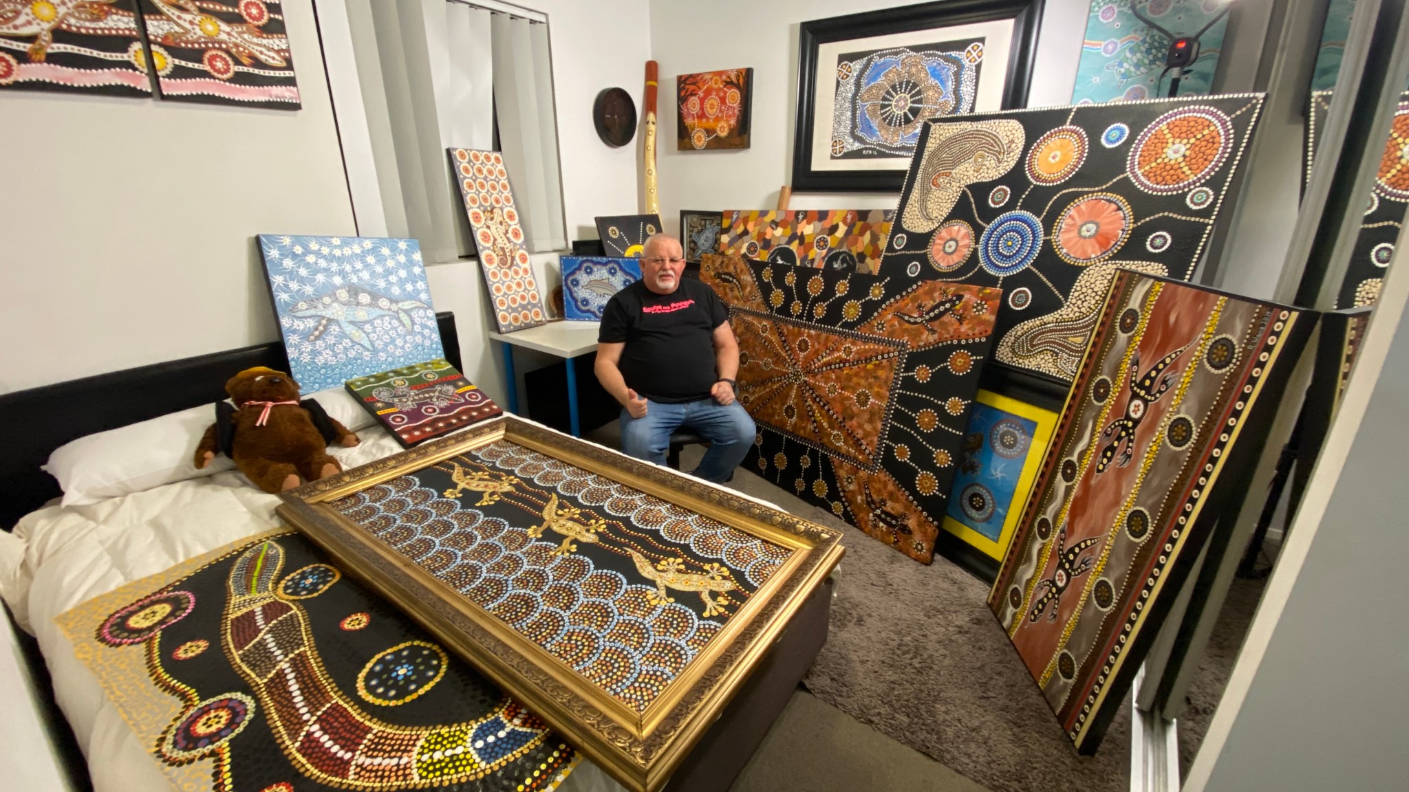 A richly detailed Aboriginal artwork by Robb Wang featuring ochre tones, emus and concentric dot patterns